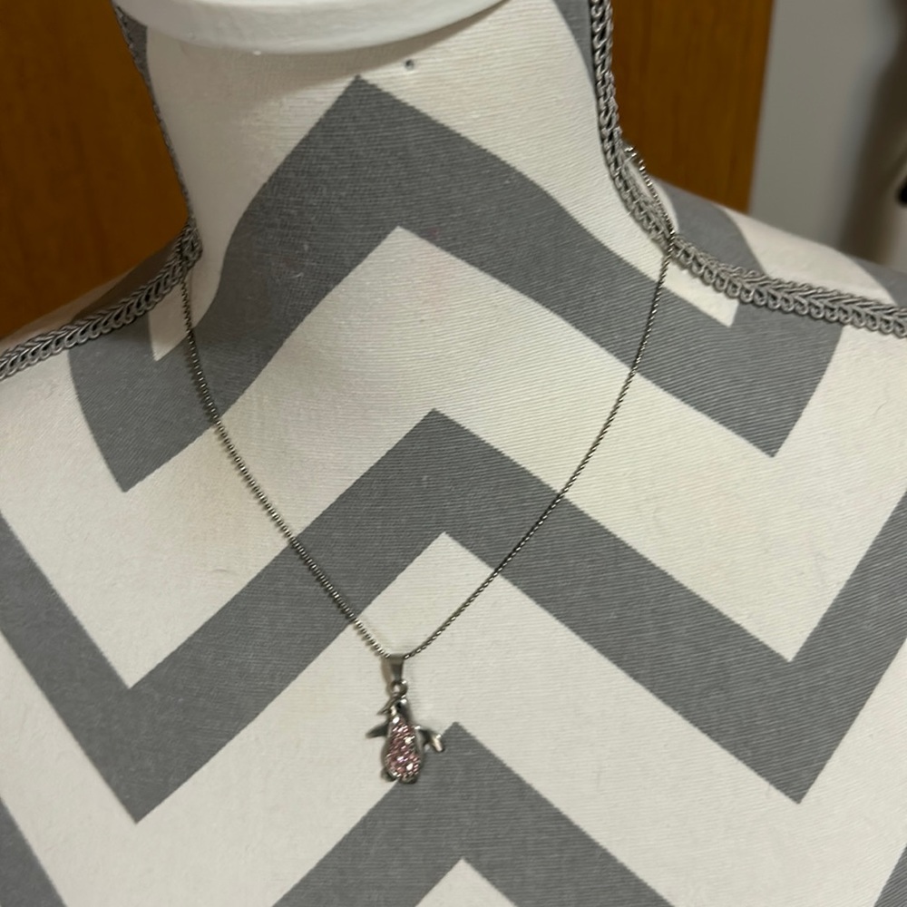 Kids 16” silver necklace with 2” extender. Has a silver penguin pendant. Used
